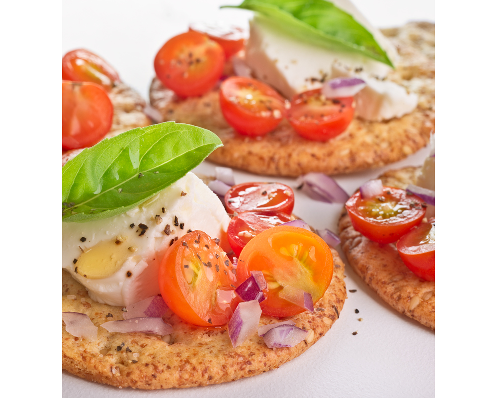 Crackers and tomatoe with diced onions and basil photo by Raoul Butler