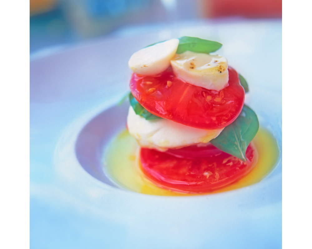 Scollops and tomatoes with basil in olive oil photo by Raoul Butler