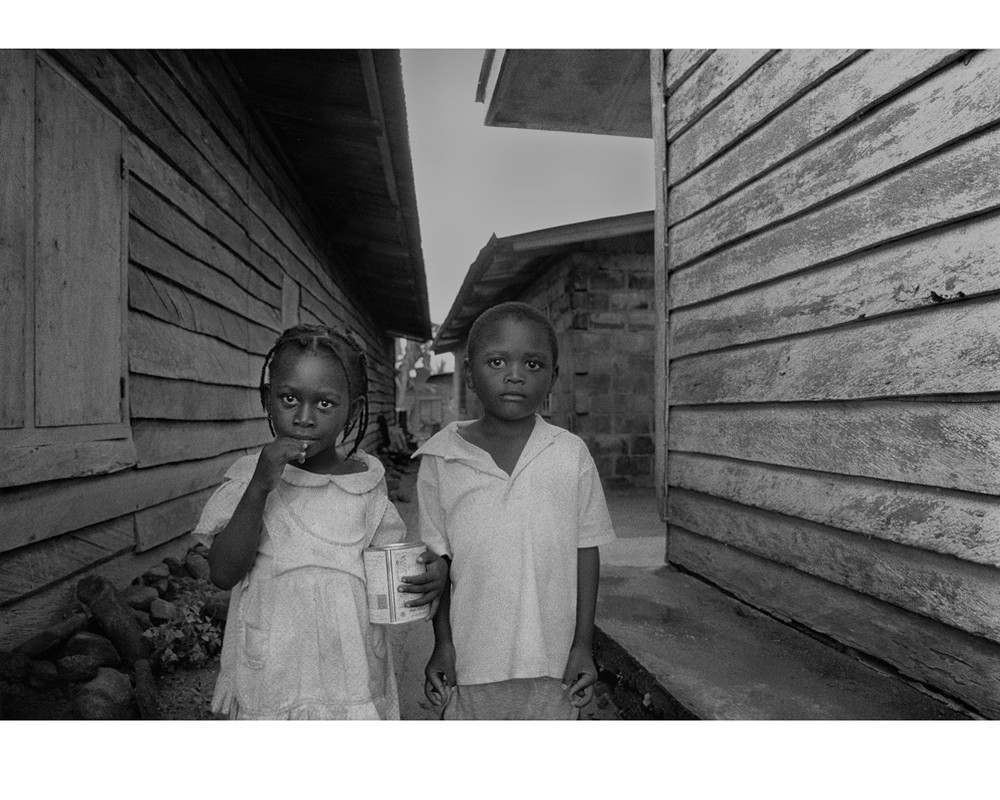 Cameroon Twins in a back street photo by Raoul Butler